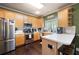 Functional kitchen with stainless steel appliances, wood cabinetry, and bright lighting at 3225 Warren Creek Sw Dr, Hiram, GA 30141