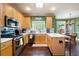 Modern kitchen featuring stainless steel appliances, wooden cabinets, and hardwood floors at 3225 Warren Creek Sw Dr, Hiram, GA 30141