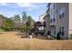 Lush backyard showcasing a patio, outdoor seating area, a deck, and mature trees at 4125 Hidden River Dr, Cumming, GA 30028
