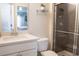 Bathroom featuring tiled shower with glass doors, quartz countertop, and tiled floor at 4125 Hidden River Dr, Cumming, GA 30028