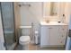 Well-lit bathroom with a toilet, shower, and a modern vanity at 4125 Hidden River Dr, Cumming, GA 30028
