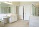 This bathroom has a double vanity and tiled shower with glass doors at 4125 Hidden River Dr, Cumming, GA 30028