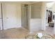 The primary bathroom features a tiled shower and walk-in closet at 4125 Hidden River Dr, Cumming, GA 30028