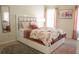 Bedroom featuring a bed with floral patterned bedding, a dresser, and modern decor at 4125 Hidden River Dr, Cumming, GA 30028