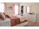 Bedroom featuring a bed with floral patterned bedding, a dresser, and a walk-in closet at 4125 Hidden River Dr, Cumming, GA 30028