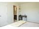 Bright bedroom featuring a comfortable bed and ensuite bathroom access through an open door, along with a wooden desk at 4125 Hidden River Dr, Cumming, GA 30028