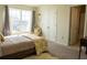 Bright bedroom featuring a comfortable bed with yellow decorative pillows and ensuite bathroom access through an open door at 4125 Hidden River Dr, Cumming, GA 30028