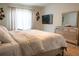 Bright bedroom with lots of natural light, a modern dresser, and decorative wall art at 4125 Hidden River Dr, Cumming, GA 30028