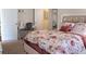 Bedroom featuring a bed with floral patterned bedding, a desk, and an ensuite bathroom access through a doorway at 4125 Hidden River Dr, Cumming, GA 30028
