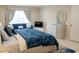 Bedroom featuring a blue sofa, TV, and a sleek dresser with mirror at 4125 Hidden River Dr, Cumming, GA 30028