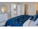 Comfortable bedroom showcasing a dresser and an open ensuite bathroom at 4125 Hidden River Dr, Cumming, GA 30028