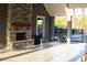 Exterior fireplace with stone surround, trash cans and lush green foliage outside at 4125 Hidden River Dr, Cumming, GA 30028