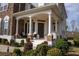 Inviting front porch with stately columns and charming seating area, perfect for enjoying the outdoors at 4125 Hidden River Dr, Cumming, GA 30028