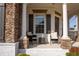 Close up of inviting front porch with charming seating area, perfect for relaxing outdoors at 4125 Hidden River Dr, Cumming, GA 30028