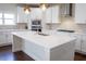 Kitchen island with quartz countertop and stainless-steel appliances at 4125 Hidden River Dr, Cumming, GA 30028