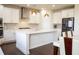 Bright kitchen features an island, modern pendant lighting, and stainless steel appliances at 4125 Hidden River Dr, Cumming, GA 30028