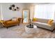 Cozy living room with stylish furniture, a large mirror, and soft, inviting decor at 4125 Hidden River Dr, Cumming, GA 30028