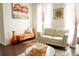 Comfortable living room with white sofas, orange bench seating, light curtains, and modern decor at 4125 Hidden River Dr, Cumming, GA 30028