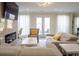 Inviting living area with a cozy fireplace, doors to outdoor space, and elegant neutral-toned furnishings at 4125 Hidden River Dr, Cumming, GA 30028