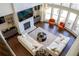 Living room featuring a fireplace, large windows, modern furniture, and elegant decor from an elevated view at 4125 Hidden River Dr, Cumming, GA 30028