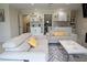 Bright living space featuring comfortable sofas, a serving area, and access to upper floor at 4125 Hidden River Dr, Cumming, GA 30028