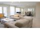Spacious living room featuring modern furniture, a dining area, and a foosball table for indoor entertainment at 4125 Hidden River Dr, Cumming, GA 30028