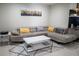 Inviting living room with a comfortable gray sectional sofa, accent pillows and contemporary white coffee table at 4125 Hidden River Dr, Cumming, GA 30028