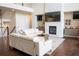 Open living room featuring a stone fireplace and a large sectional sofa at 4125 Hidden River Dr, Cumming, GA 30028