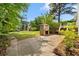 Large backyard has a stone cooking area and mature trees, providing a private outdoor space at 112 Bernice Dr, Lawrenceville, GA 30045