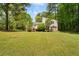 Expansive backyard with a well-maintained lawn and the home in the background at 112 Bernice Dr, Lawrenceville, GA 30045