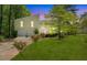 Charming home with a well-maintained lawn, mature trees, and an inviting front entrance at 112 Bernice Dr, Lawrenceville, GA 30045