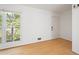 Bright, sunny living room with gleaming hardwood floors and a large window with a lovely view at 112 Bernice Dr, Lawrenceville, GA 30045