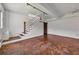 Open basement featuring concrete floors, white walls, exposed ceiling, and a staircase at 172 Haynes Sw St # 108, Atlanta, GA 30313