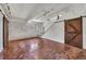 Spacious basement with concrete floors, sliding barn doors, and modern track lighting at 172 Haynes Sw St # 108, Atlanta, GA 30313