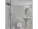 Bathroom featuring a walk-in shower, pedestal sink, and honeycomb tile flooring at 172 Haynes Sw St # 108, Atlanta, GA 30313