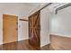 Entryway with a sliding barn door, standard door, coat hooks, and hardwood floors at 172 Haynes Sw St # 108, Atlanta, GA 30313