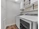 Laundry room equipped with washer, dryer, and white cabinets for ample storage at 172 Haynes Sw St # 108, Atlanta, GA 30313