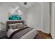 Comfortable main bedroom with hardwood floors, a queen bed, and scenic wall art at 172 Haynes Sw St # 108, Atlanta, GA 30313