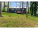 Spacious backyard featuring mature trees, a wooden deck, and a well-maintained lawn at 2318 Plantation Dr, Atlanta, GA 30344