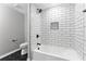 Modern bathroom with subway tile shower, sleek fixtures, and stylish design with black hex floor tiles at 2318 Plantation Dr, Atlanta, GA 30344