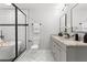 Bright bathroom featuring white subway tiles, a glass enclosed shower and soaking tub, and dual sinks at 2318 Plantation Dr, Atlanta, GA 30344