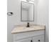 Bathroom vanity with a neutral granite countertop, modern fixtures, and a sleek, minimalist mirror at 2318 Plantation Dr, Atlanta, GA 30344