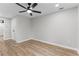 Bedroom featuring neutral walls, hardwood floors, a ceiling fan, and a closet at 2318 Plantation Dr, Atlanta, GA 30344