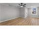 This finished bedroom has modern plank floors, ceiling fan, and a window with natural light and a closet at 2318 Plantation Dr, Atlanta, GA 30344