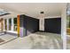 Spacious carport featuring modern lights, direct house access, and durable concrete flooring at 2318 Plantation Dr, Atlanta, GA 30344