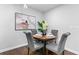 Cozy dining area with modern light fixture, table set for four, and contemporary art at 2318 Plantation Dr, Atlanta, GA 30344