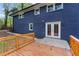 Exterior view of the house with a dark blue painted brick exterior, wooden deck, and double glass doors at 2318 Plantation Dr, Atlanta, GA 30344