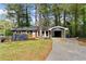 Charming home featuring a brick facade, orange shutters and a convenient carport at 2318 Plantation Dr, Atlanta, GA 30344