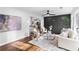 View of the living room area with an accent wall, hardwood floors, a ceiling fan, and an open layout at 2318 Plantation Dr, Atlanta, GA 30344