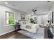 Cozy main bedroom featuring hardwood floors, natural light, and a ceiling fan at 2318 Plantation Dr, Atlanta, GA 30344